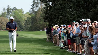 Tiger Woods walks to the ninth tee during a practice round prior to The Masters as hundreds of fans watch behind the ropes. AFP
