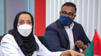 Dr Al Kaabi, pictured with Ashish Koshy, chief executive of Sinopharm vaccine trial partner G42 Healthcare, said the country aims to inoculate 70 per cent of the population to achieve herd immunity. Victor Besa / The National