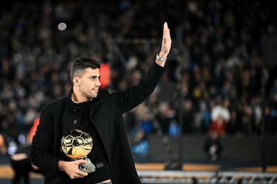 Manchester City's Spanish midfielder Rodri parades his Ballon d'Or award at the Etihad Stadium. AFP