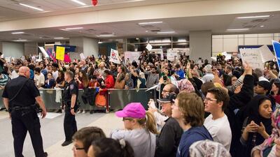 People gather to protest against the travel ban imposed as a result of Donald Trump's executive order at Dallas-Fort Worth International Airport on January 28, 2017. Laura Buckman/Reuters
