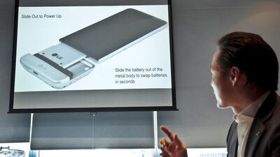 Frank Lee, the director of communications for LG’s US mobile business, shows the LG G5 phone with the bottom of the phone pulled out. The phone’s bottom contains the battery, which can be removed and inserted into a different module with extra features, such as a camera grip with physical shutter buttons. Bebeto Matthews / AP Photo