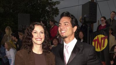 Julia Roberts, in brown suede, and Benjamin Bratt, attend the 7th annual Screen Actors Guild Awards on March 11, 2001 at the Shrine Auditorium in Los Angeles, California. Getty Images