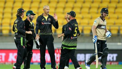 Australia's Ashton Agar, centre, celebrates the wicket of New Zealand batsman Jimmy Neesham for a duck during the third T20 International in Wellington on March 3. Australia won the match by 64 runs. Getty