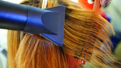 Detail of a woman having her hair dried by a hairdresser (iStockphoto.com)