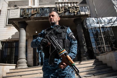 A member of the internal security forces stands in front of Sweida's police station. Hasan Belal for The National