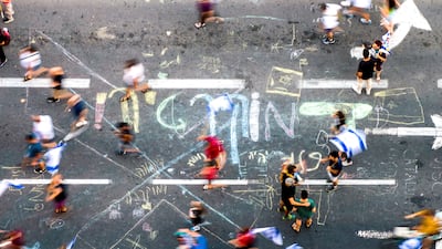 The Hebrew word for 'democracy' is daubed on a road during a demonstration against Israeli Prime Minister Benjamin Netanyahu's government in Tel Aviv. Reuters