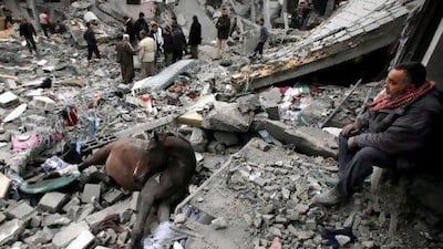 A dead horse lays in the rubble as Palestinians inspect homes destroyed by Israeli missiles strikes in 2009. Recent leaked documents show that the Palestinian Authority agreed to delay a UN vote that would have condemned Israel for its invasion of the Gaza Strip.