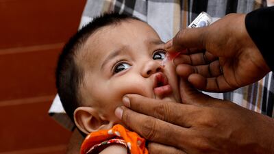 A girl receives vaccine drops during an anti-polio campaign in a low-income neighbourhood in Karachi. Reuters