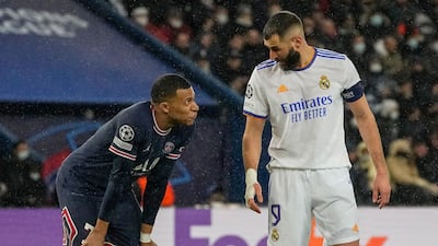PSG's Kylian Mbappe, left, talks with Karim Benzema of Real Madrid during the Champions League last-16, first leg in 2022. AP