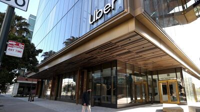 A pedestrian walks by the new Uber headquarters in San Francisco. Getty