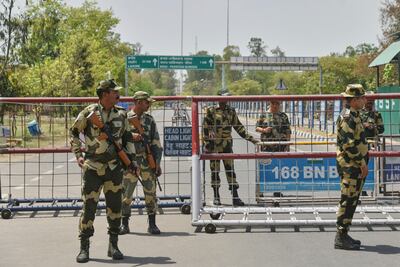 Indian border guard troops guard a road leading to the Attari-Wagah border, which is being closed in response to the Kashmir attack. AP