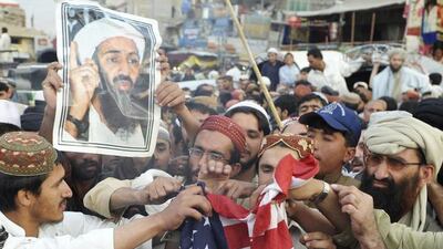 Taliban supporters burn a US flag during an anti-American rally in Quetta on May 2, 2012 on the first anniversary of the death of Osama bin Laden. Banaras Khan / AFP