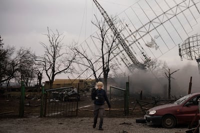 Associated Press videographer Mstyslav Chernov walks amid smoke rising from an air defense base in the aftermath of a Russian strike in Mariupol. AP Photo