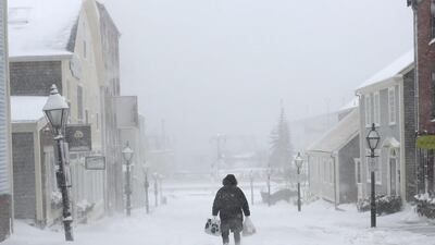 A woman walks down the street in New Bedford, Massachusetts during a snowstorm affecting the north-east of the United States. Peter Pereira / Standard Times via AP
