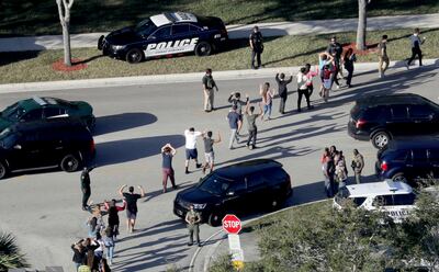 Students are evacuated by police from Marjory Stoneman Douglas High School in Parkland, Florida after Cruz opened fire on the campus. AP