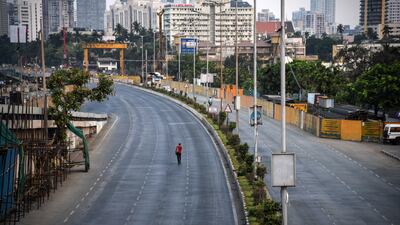 A pedestrian walks along a near-deserted street during a lockdown imposed in 2021 in Mumbai, India