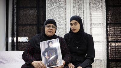 Majeda Abu-Sharkh left, holds a picture of her murdered daughter as she poses for a photograph with her niece Alaa Khalili in Lod, central Israel. Dan Balilty/AP Photo