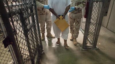 United States military guards move a detainee inside Camp VI at Guantanamo Bay, Cuba. Paul J Richards / AFP Photo