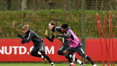 Brandon Williams, James Garner and Angel Gomes of Manchester United participate in a training session. Getty Images