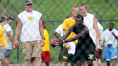 Brett Favre has been a fixture at Oak Grove High School for several summers, working with players during their summer practices.