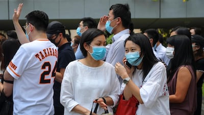 Masked protesters march in the street. EPA