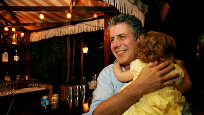 Chef Anthony Bourdain holds his daughter Ariane in Miami Beach back in 2008. Court papers show that Bourdain was worth $1.2 million when he died last month. Most of the estate has been left to his daughter, who is now 11-years-old. Lynne Sladky / AP photo