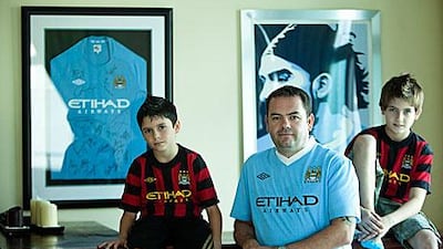 Darren Ball, centre, and his sons, Aidan, left, and Declan, are huge Manchester City fans.
