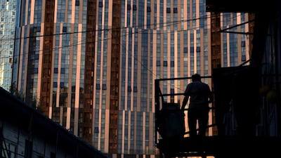 A construction worker walks down a staircase near a commercial complex in Beijing. Foreign direct investment into China dropped by more than a sixth year-on-year in July, the government said on August 18. Greg Baker / AFP