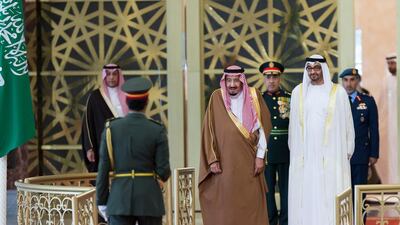 Sheikh Mohammed bin Zayed, Crown Prince of Abu Dhabi and Deputy Supreme Commander of the UAE Armed Forces, centre right, and King Salman bin Abdulaziz Al Saud, Custodian of the Two Holy Mosques, centre left, stand for the national anthem during a reception at the presidential airport. Philip Cheung / Crown Prince Court – Abu Dhabi