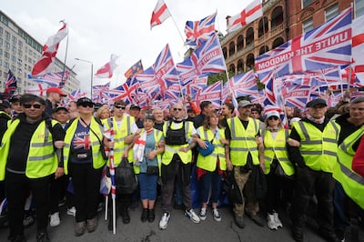 Activists fly the Union Jack and St George's Cross during the London march. PA
