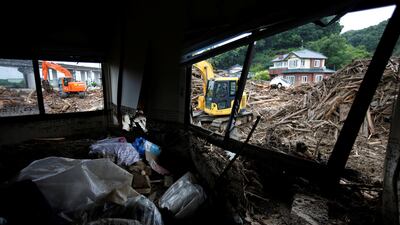 Workers use extravators to remove debris which were swept away by heavy rain in Asakura, Fukuoka Prefecture, Japan July 9, 2017. REUTERS/Issei Kato