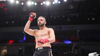 Tahar Hadbi from Algeria, in black shorts, fights Yoichiro Satofrom from Japan in the Abu Dhabi Warriors 4 at IPIC Arena in Zayed Sports city in Abu Dhabi. Ravindranath K / The National