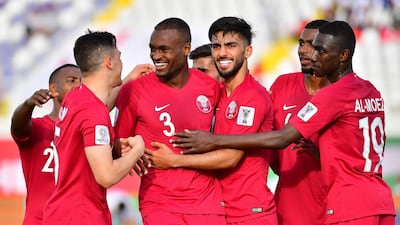Qatar defender Abdelkarim Hassan, third left, celebrates after scoring against North Korea. AFP