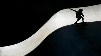 Ten-year-old Dylan Pacheco, from Jerome, Idaho, skates along a a ribbon of sunlight at the Rhodes Skate Park grand opening in Boise, Idaho. Kyel Green / Idaho Statesman via AP