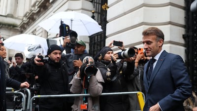 Mr Macron arrives at Downing Street. AFP
