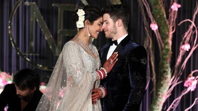 Newlyweds Priyanka Chopra, 36, and Nick Jonas, 26, pose for a photograph during a reception at a hotel in New Delhi on December 4, 2018. Photo: EPA