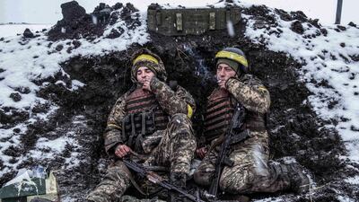 Ukrainian soldiers in their foxhole, north of the city of Kharkiv, on the second day of Russia's invasion. Taken by Julian Simmonds. PA
