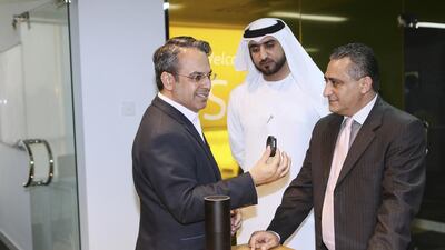 Vimal Sethi, left, managing director of Synechron Middle East, makes a demonstration at the Synechron launch in Dubai Media City. Sarah Dea / The National