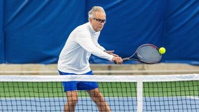 Tennis player Charlie Siracusa, 70, practises.