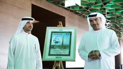 Ibrahim bin Karam, chief commercial officer of Emirates Post Group, and Ahmed Al Falasi , executive director at Emaar Properties, pose with a mock-up of the stamp to commemorate the sixth anniversary of the opening of the Burj Khalifa. Pawan Singh / The National