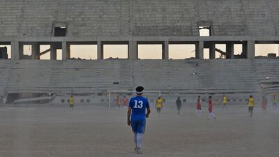 Players of Al Mosul FC practise at the ravaged Al Idara Al Mahalia stadium, which was once used by ISIS as a weapons depot, near the northern Iraqi city of Mosul. AFP