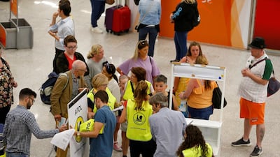 Passengers talk to the Civil Aviation Authority after the world's oldest travel firm collapsed stranding hundreds of thousands of holidaymakers around the globe and sparking the largest peacetime repatriation effort in British history, in Palma de Mallorca, Spain. Reuters