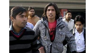 Mohammad Aamer, centre, is planning to appeal. KM Chaudary / AP Photo