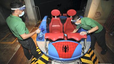 Sarfarag, left, and Surya clean the Spider-Man Doc Ock’s Revenge ride at IMG Worlds of Adventure. Chris Whiteoak / The National