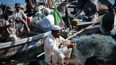 Zahid Hussain, 27, sorts his daily catch on a fishing boat at Karachi's fish harbour. “They will give jobs to people from communities with political connections," Mr Hussain said.