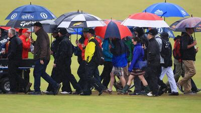 Spectators use umbrellas to shelter from the rain as they walk between holes during the second round on day two of the 145th Open Championship at Royal Troon on July 15, 2016 in Troon, Scotland. (Photo by Matthew Lewis/Getty Images)
