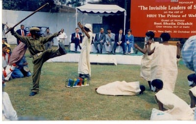 Prince Charles watches a performance by street children in New Delhi during a visit to India in October 2003. Photo: Jhamghat