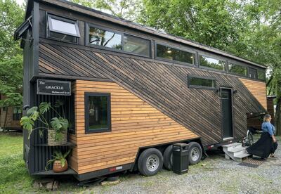 Melissa Meshey walks out of her tiny home called Grackle, built at Liberation Tiny Homes, in Elizabethtown, Pennsylvania. AFP