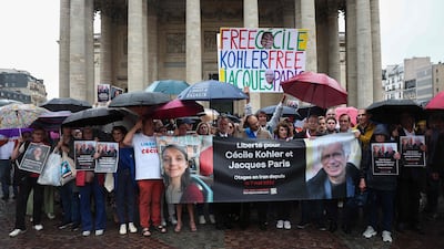 Relatives and supporters hold a rally in the French capital for Cecile Kohler and Jacques Paris, who have been held in Iran since May 2022 on espionage charges. AFP