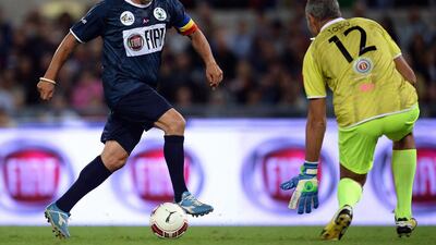 Italy great Roberto Baggio, left, shoots against goalkeeper Paolo Toldo during the “Match for Peace” game at Rome’s Olympic Stadium on September 1, 2014. Filippo Monteforte / AFP